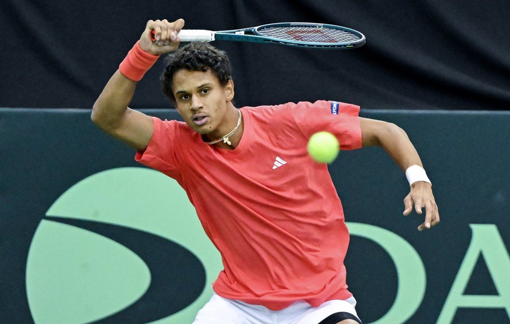 Gabriel Diallo, of Canada, plays a shot to Fabian Marozsan, of Hungary, during their Davis Cup qualifying tennis match in Montreal on Sunday, February 2, 2025. THE CANADIAN PRESS/Graham Hughes