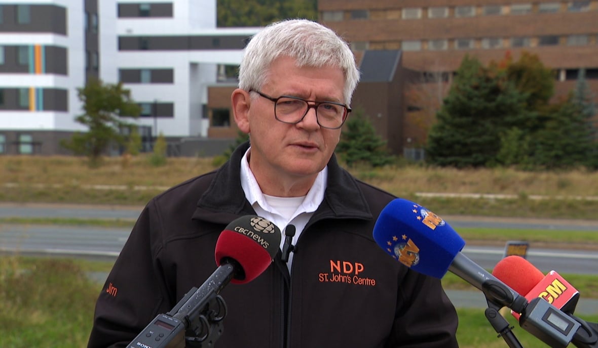 A man standing a podium outdoors.