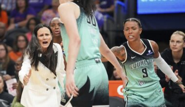 New York Liberty head coach Sandy Brondello, left, and Natasha Cloud (9) cheer on Breanna Stewart, center, during the first half of Game 1 against the Phoenix Mercury in the first round of the WNBA basketball playoffs Sunday, Sept. 14, 2025, in Phoenix. (AP Photo/Darryl Webb)