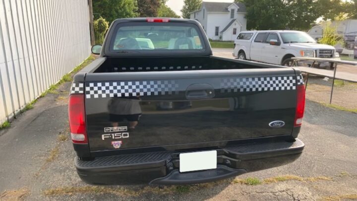 A photo showing the exterior of a 1998 Ford F-150 NASCAR Edition pickup from a rear angle.
