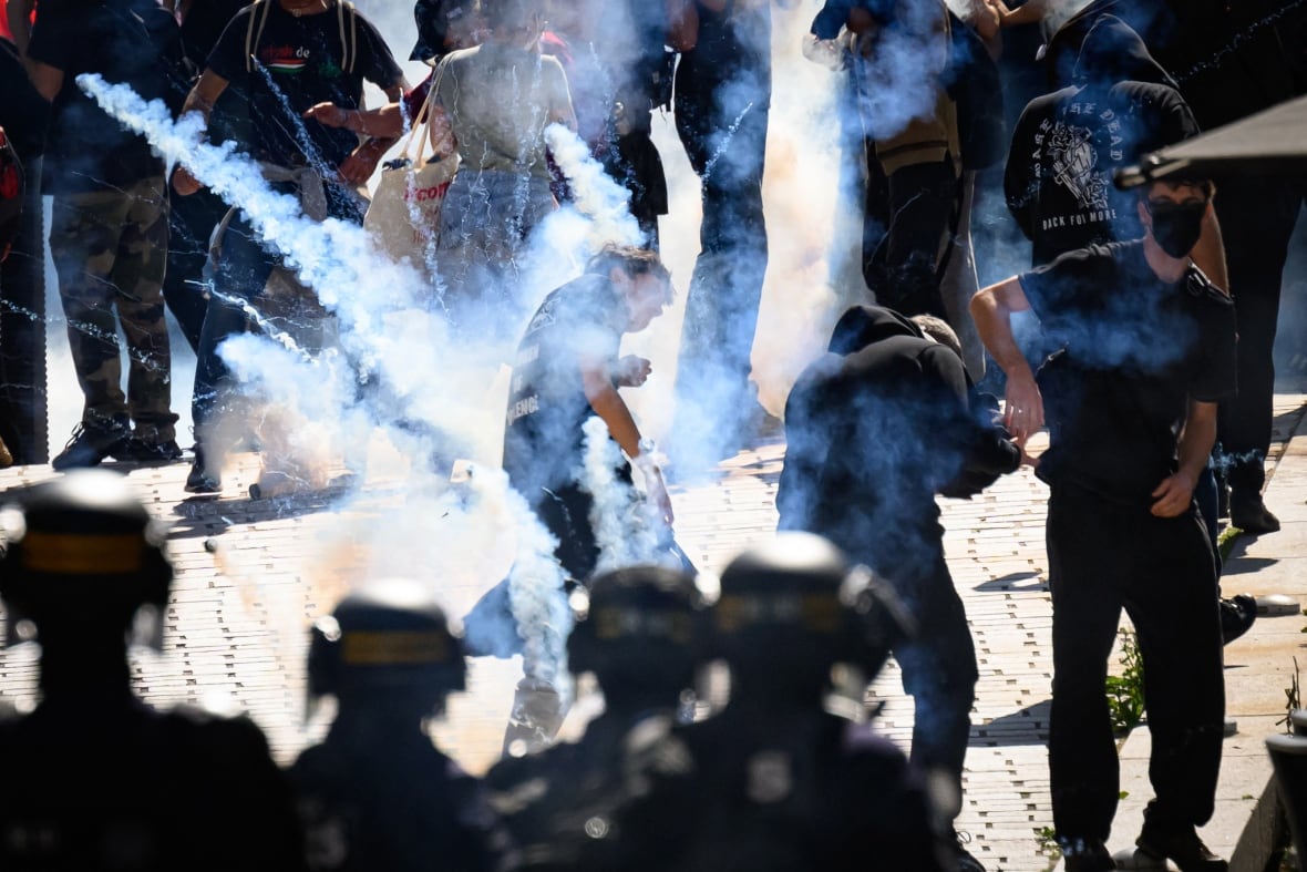 Protesters in the centre amid tear gas that's been thrown by anti-riot police. 