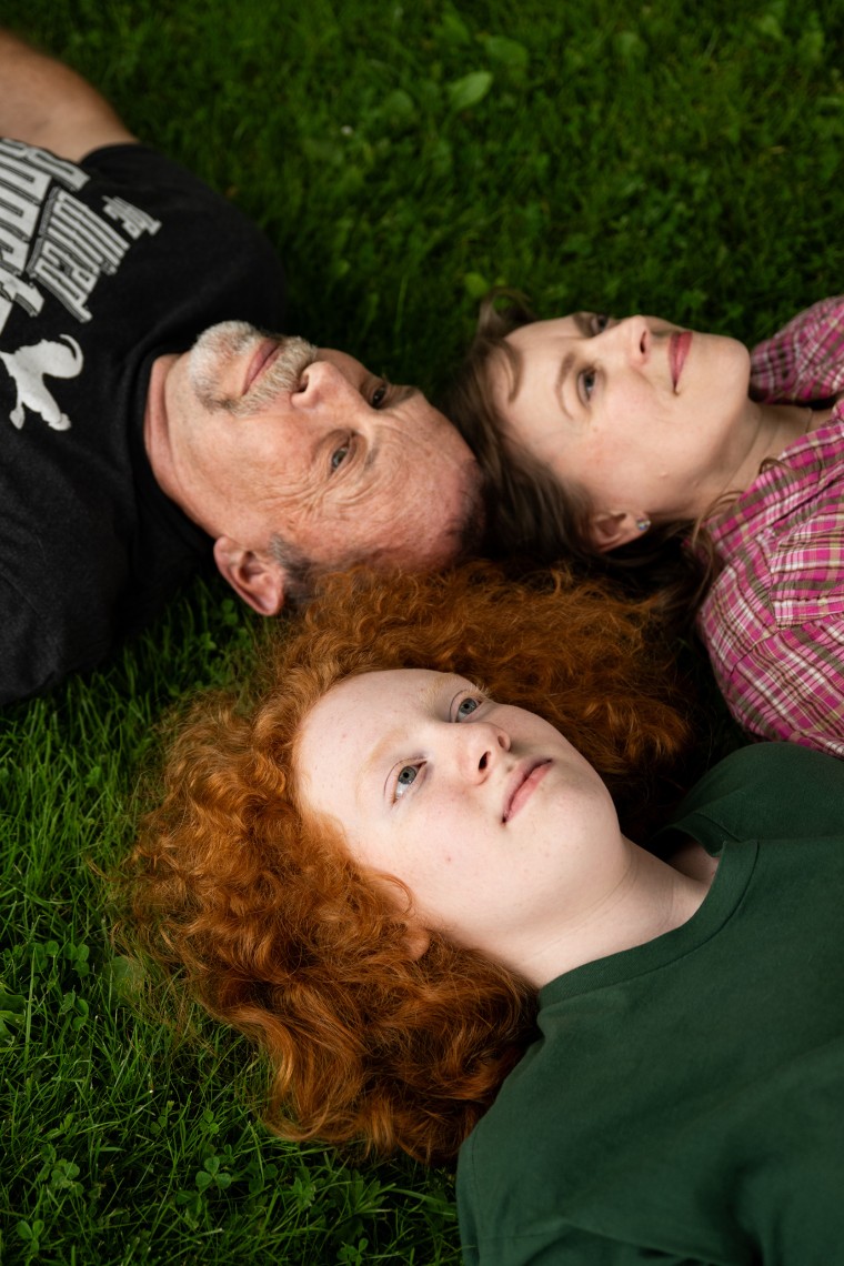 The Safford family lying on the grass.