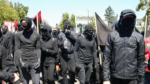 Getty Images Black-clad anti-fascist activists at protests in Berkeley, California
