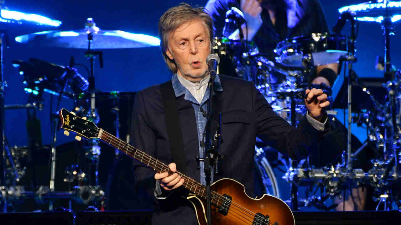 Paul McCartney performing onstage in 2024