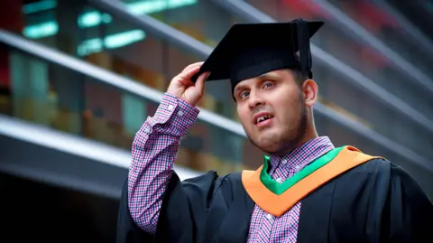 De Montfort University Leicester Haseeb Jabbar with a graduation gown and cap on