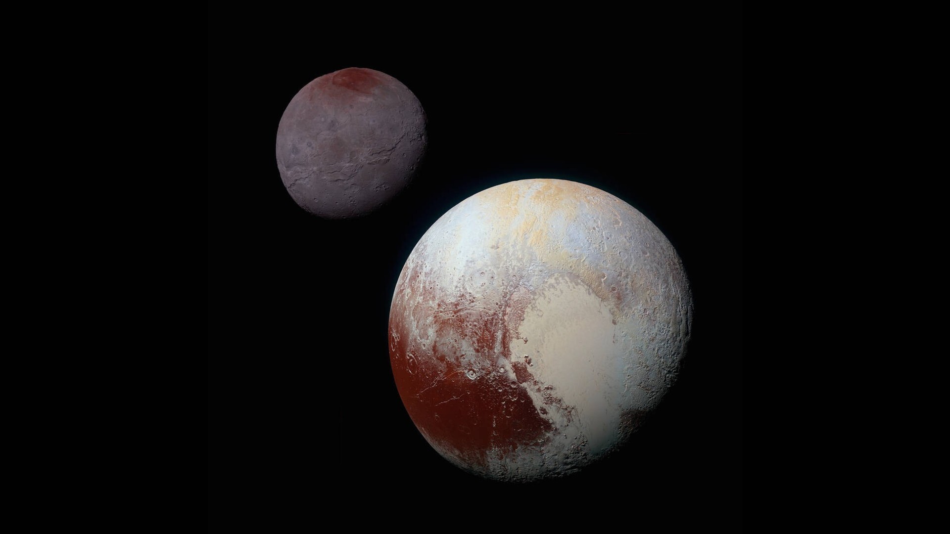 A sphere in the foreground that is white-ish with a red splotch toward the bottom left. In the background, there is a purplish sphere with redness on its top.