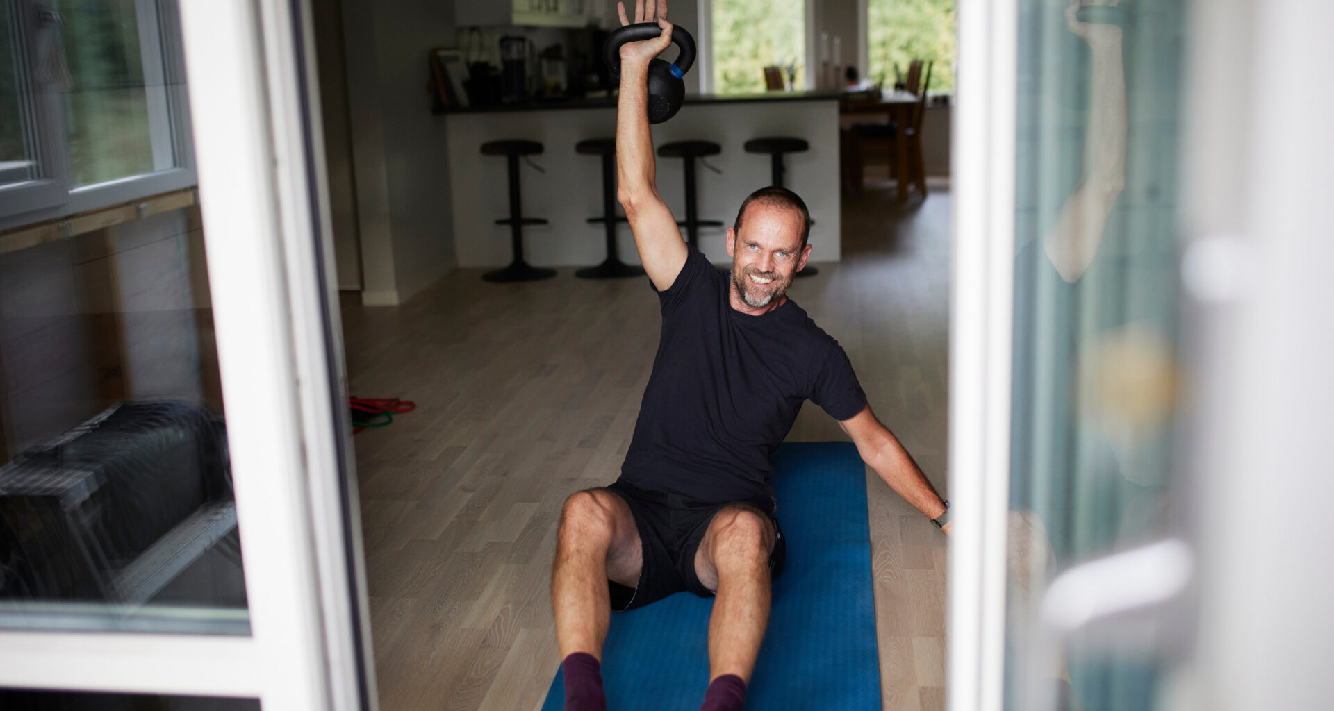 Man exercising with kettlebell at home