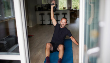 Man exercising with kettlebell at home