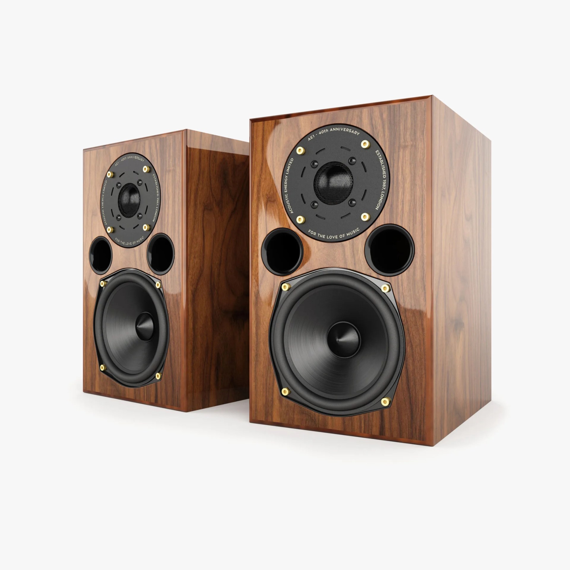 Pair of bookshelf speakers with a polished wood finish, featuring a black tweeter surrounded by a circular plate with gold screws and two circular bass ports above a large black woofer with gold screws.