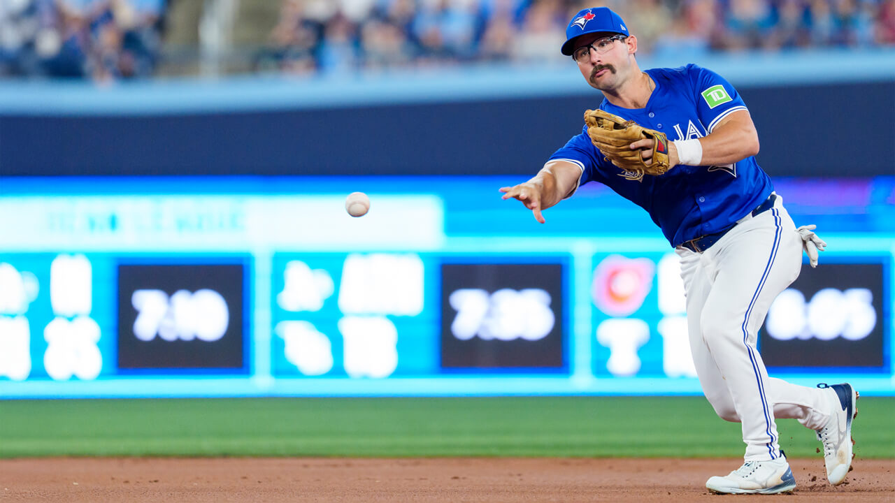 Toronto Blue Jays' utilityman Davis Schneider makes a play to first base against the New York Yankees in late June. (Photo by Thomas Skrlj/CP)