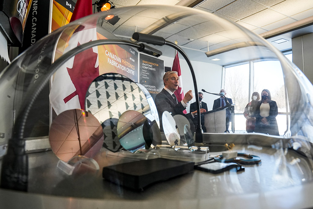 Innovation Minister François-Philippe Champagne is seen through a display of silicon wafers at the National Research Council’s Canadian Photonics Fabrication Centre in Ottawa in February 2022.
