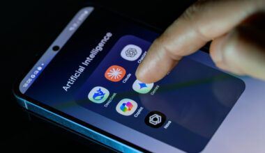 A photo of someone's smartphone with a folder full of AI apps: DeepSeek, Claude, ChatGPT, Copilot, Gemini, AI Photo, and Nova.