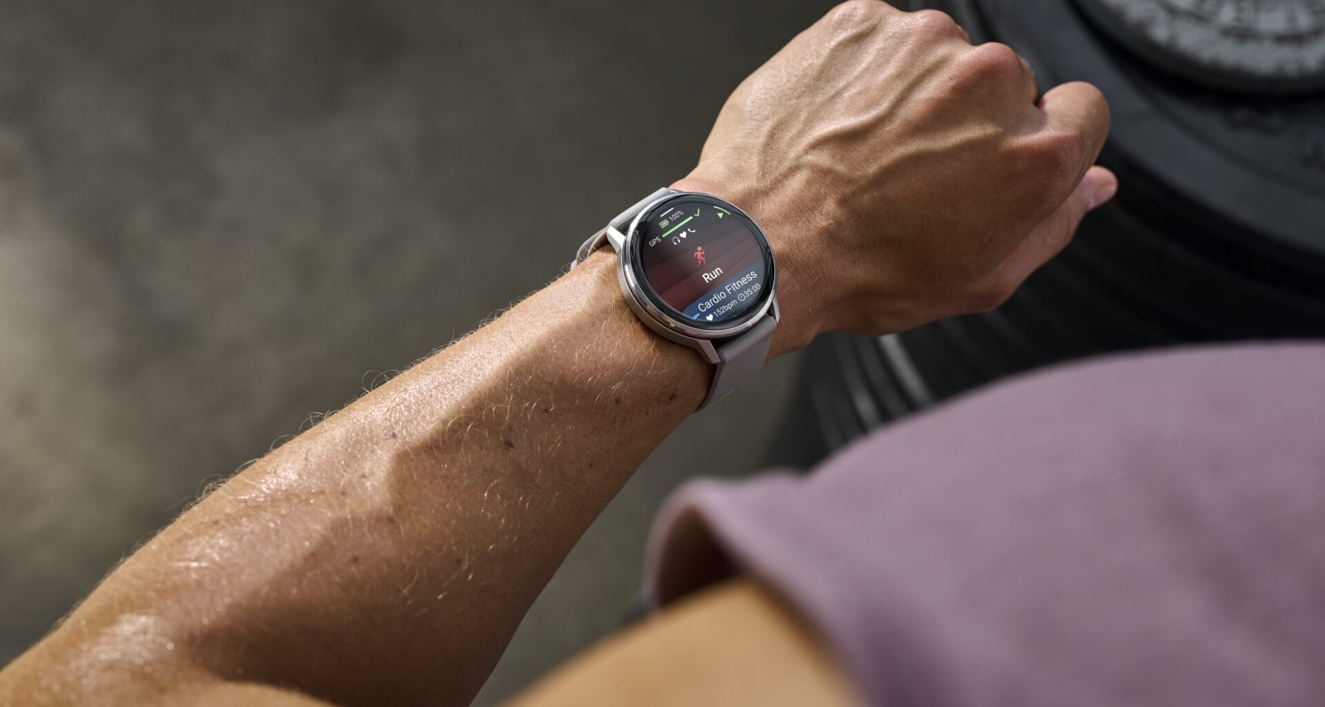 A photo of the Garmin Venu 4 on an athlete's wrist, showing a Run activity start screen.