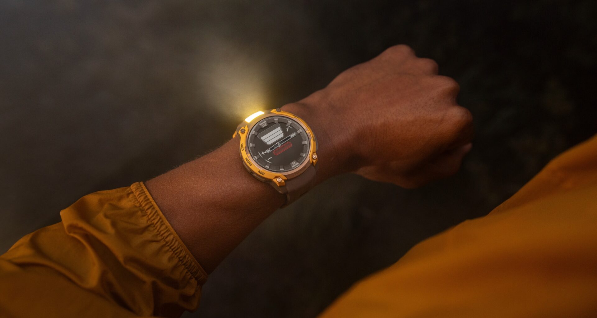 A photo of the Garmin Instinct Crossover AMOLED watch with the flashlight active on a person's wrist at night