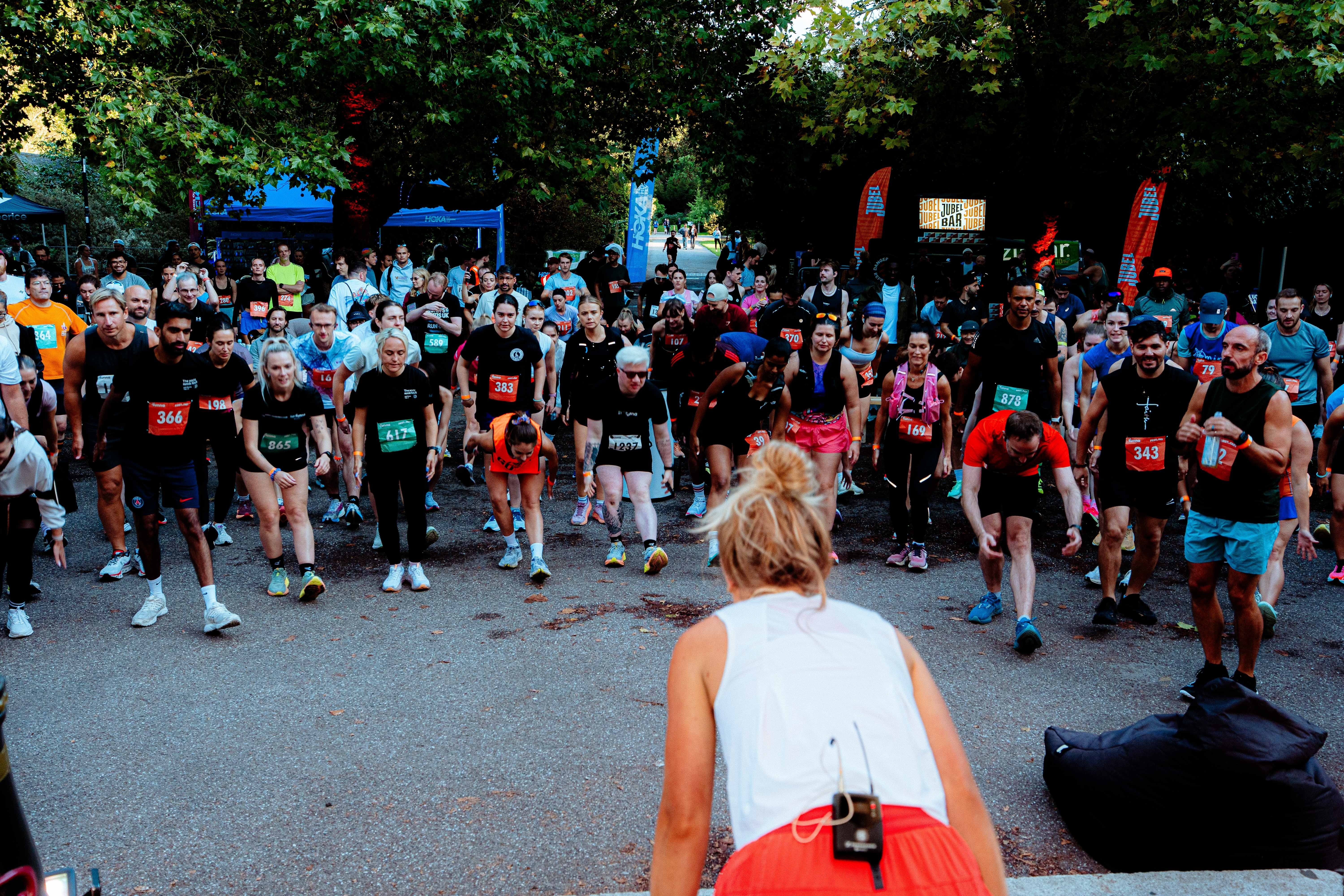 Runner Anya Culling leading Runna race participants through a warm-up
