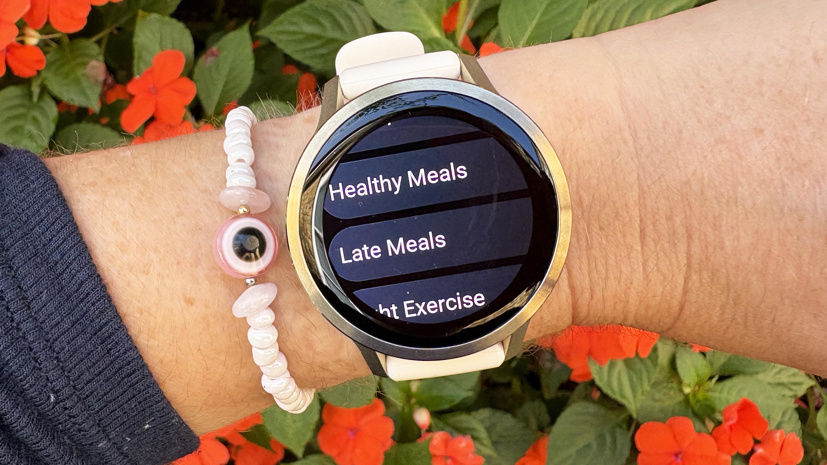 the Garmin Venu 4 in lunar gold on the wrist