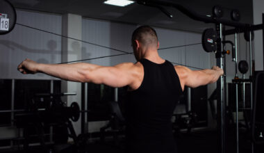 A man doing reverse cable flyes