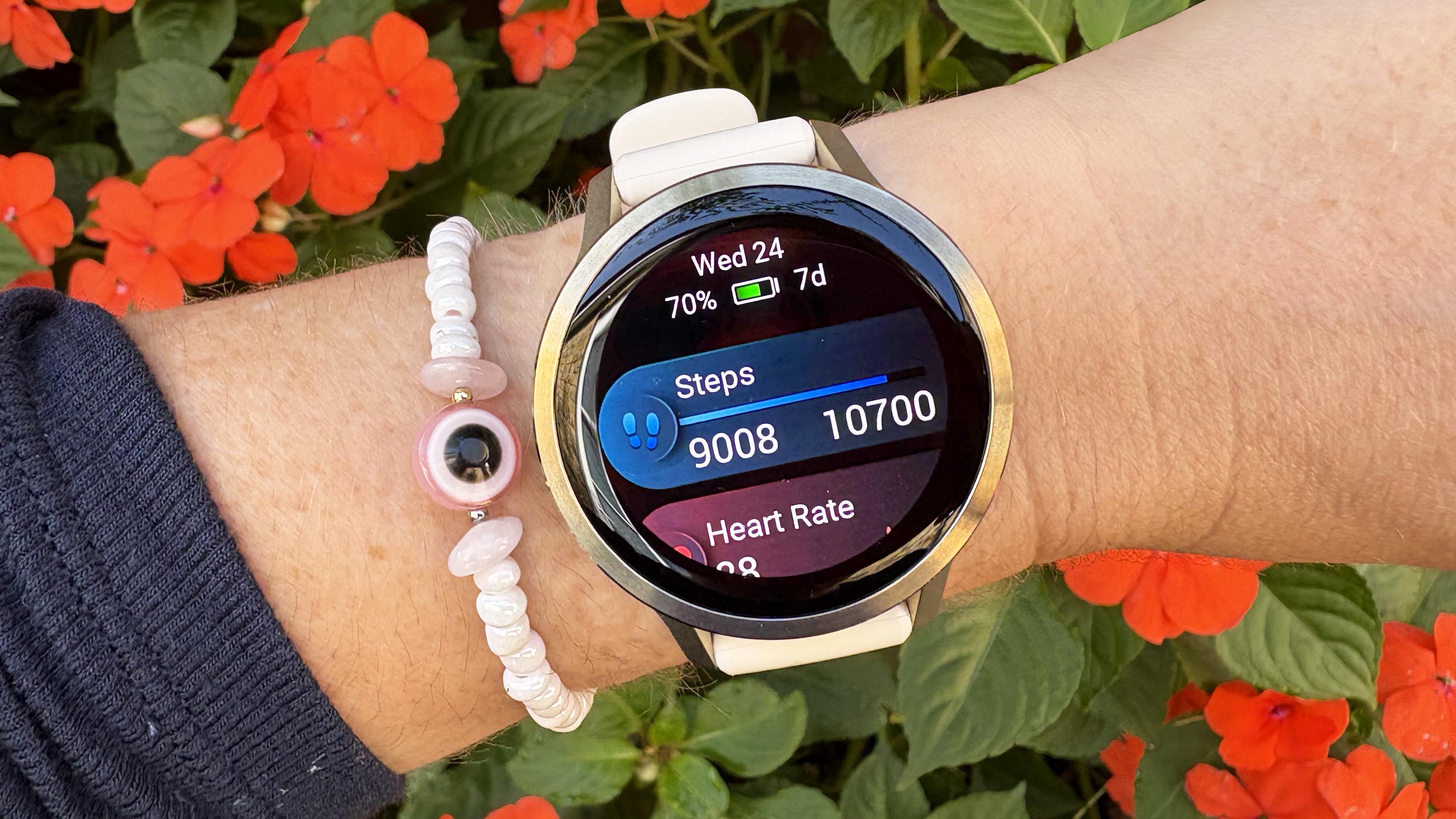 the Garmin Venu 4 in lunar gold on the wrist