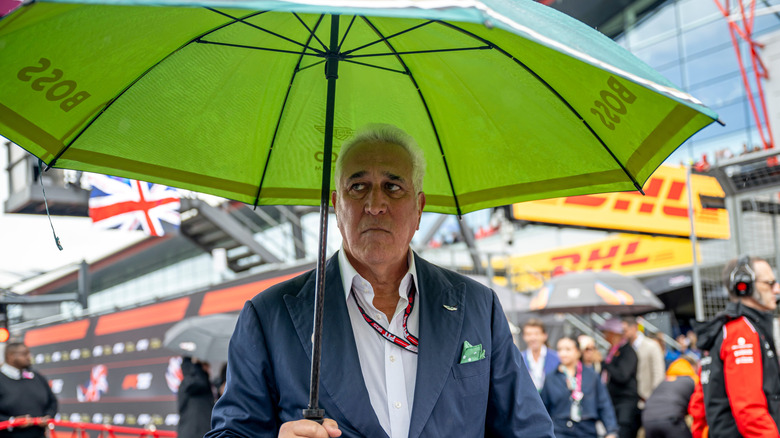 Lawrence Stroll walking with an umbrella at Silverstone