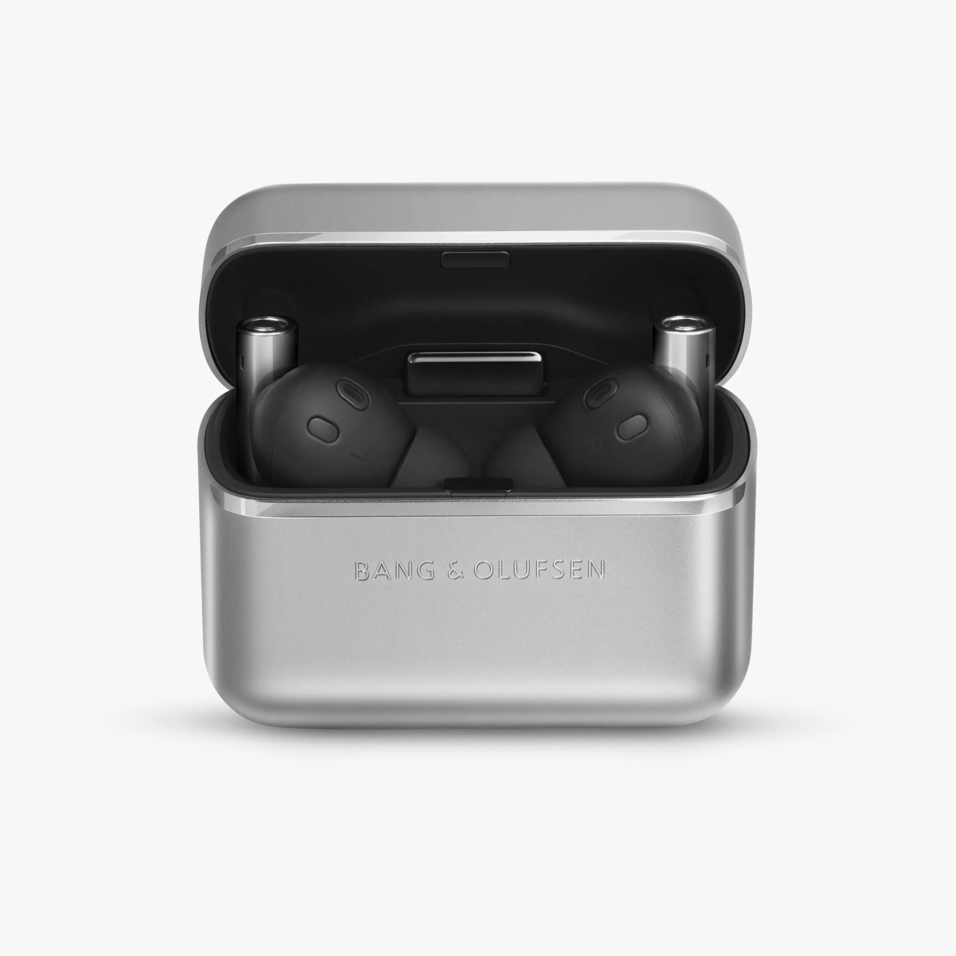 A pair of black wireless earbuds resting inside an open silver charging case with 
