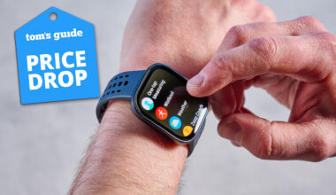 Amazfit Bip 6 on a man's arm on a grey background with a blue price drop tag.