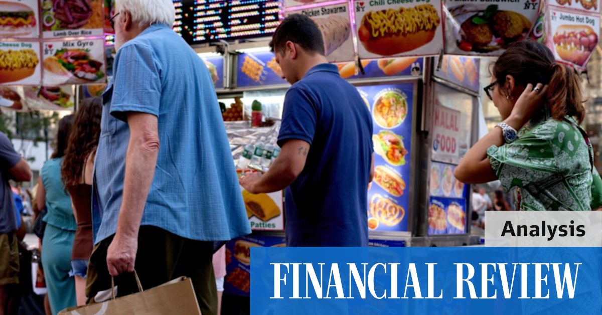 A pedestrian carries a Macy’s Inc. branded shopping bag in New York on Tuesday.