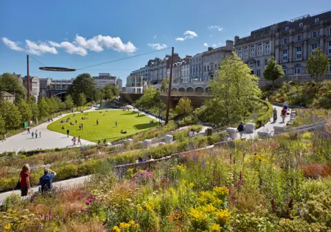 Andrew Lee A view of Union Terrace Gardens showing the stunning plant arrangements, a grassy area in the centre and people walking around enjoying the space.