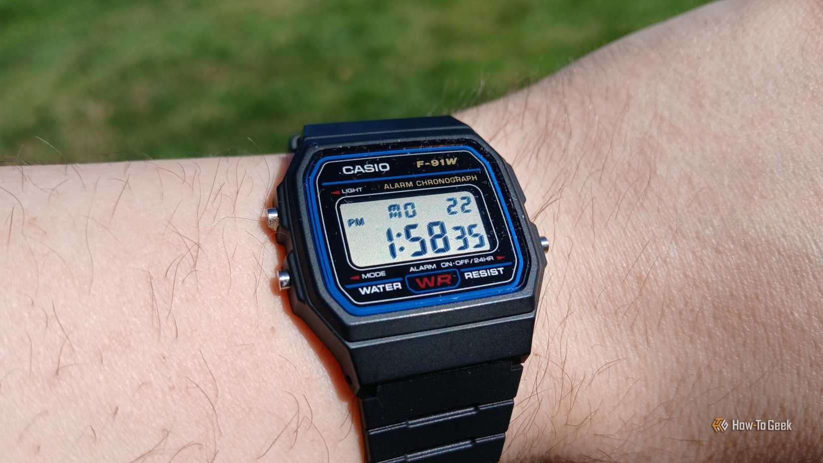 Casio F-91W watch face on a wrist.