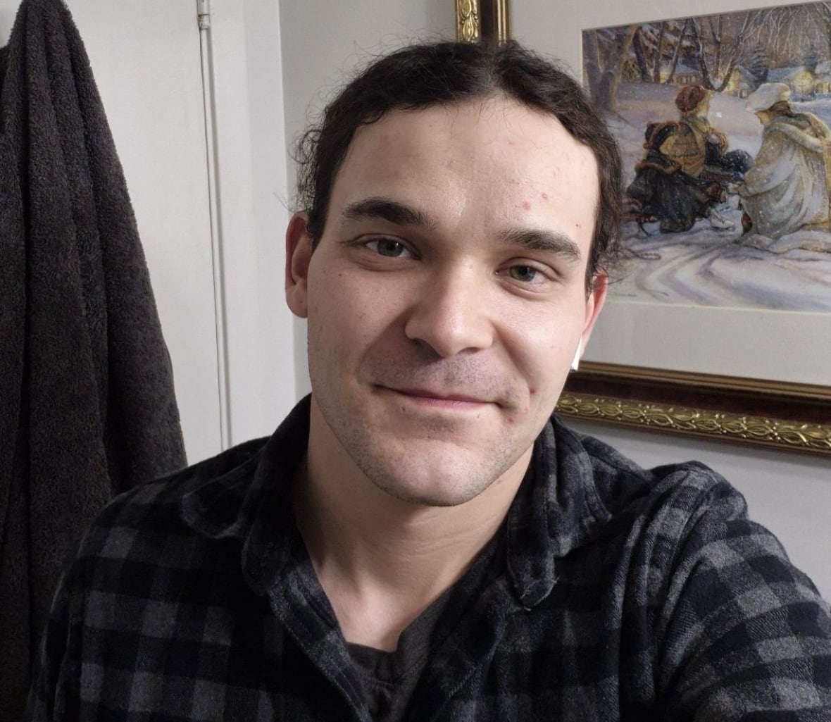 man in plaid shirt smiling