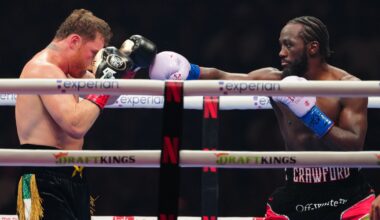 Terence Crawford punches Canelo Alvarez with his right arm boxing glove.