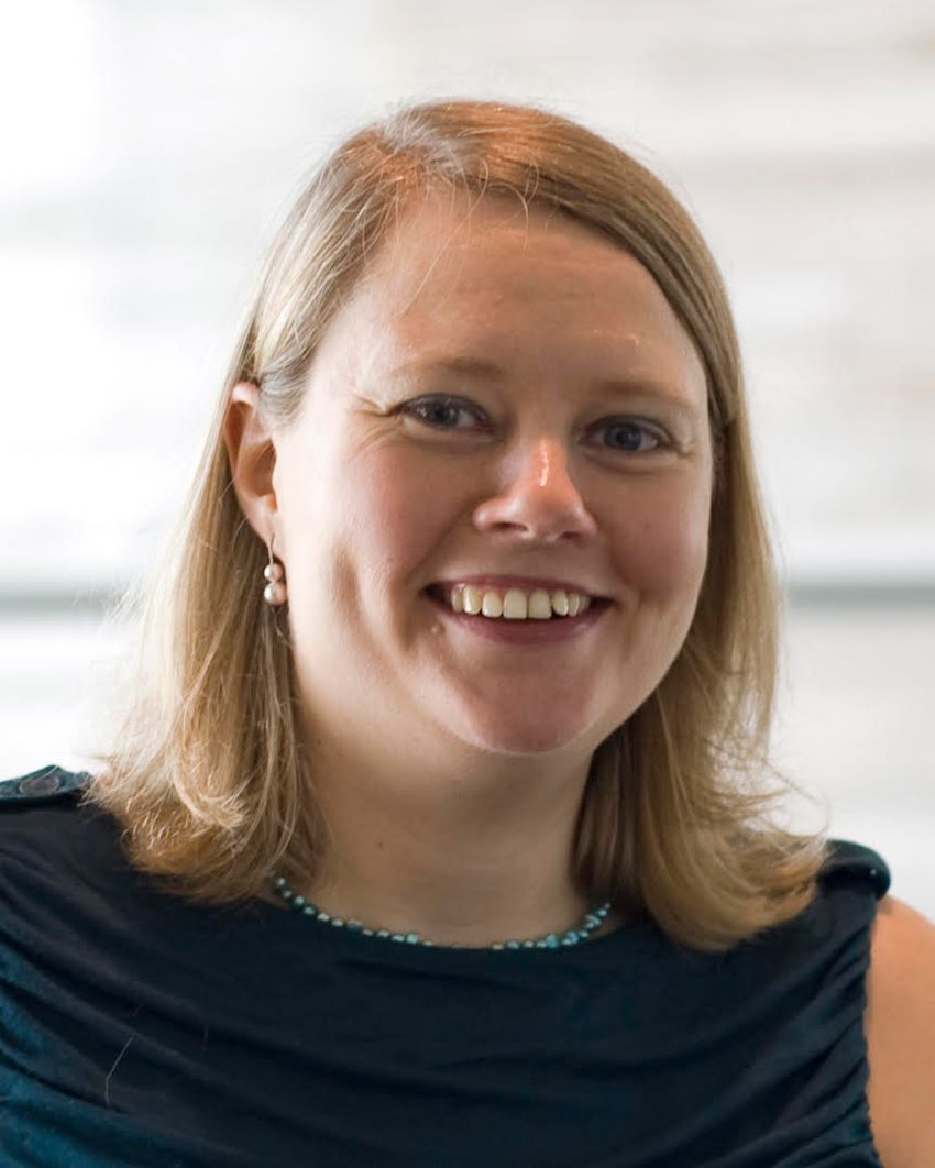 A photograph of Elinor Karlsson, who studies animal genomics, in a black top. A photograph of Elinor Karlsson, who studies animal genomics, in a black top.