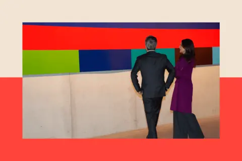 Getty Images King Frederik X of Denmark and Queen Mary of Denmark look at a brightly colour art work 