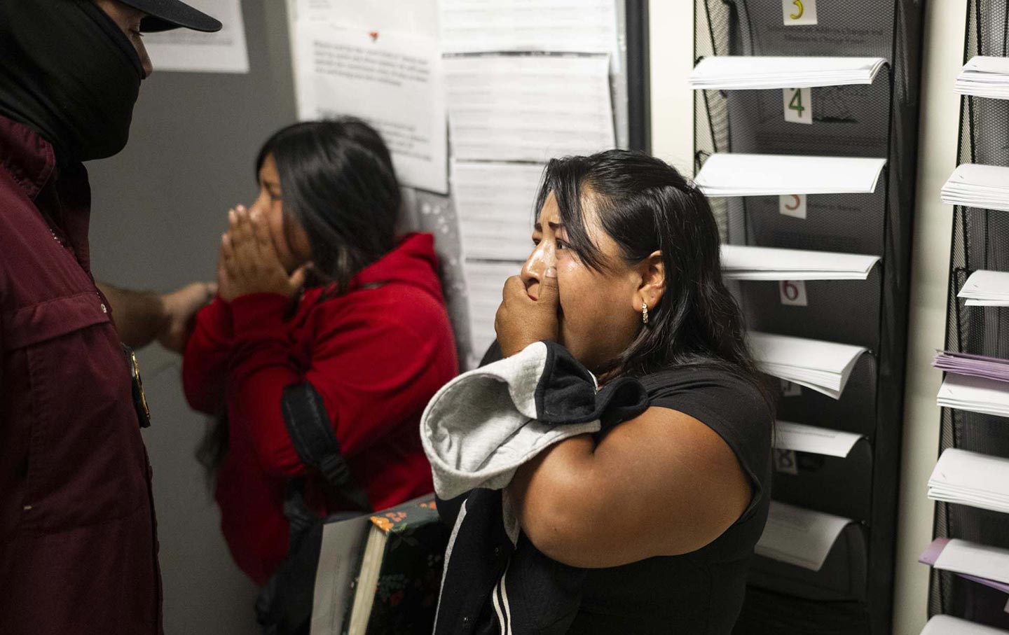 A woman reacts as a family member is detained by federal agents after exiting immigration court at the Jacob K. Javits Federal Building in New York City.