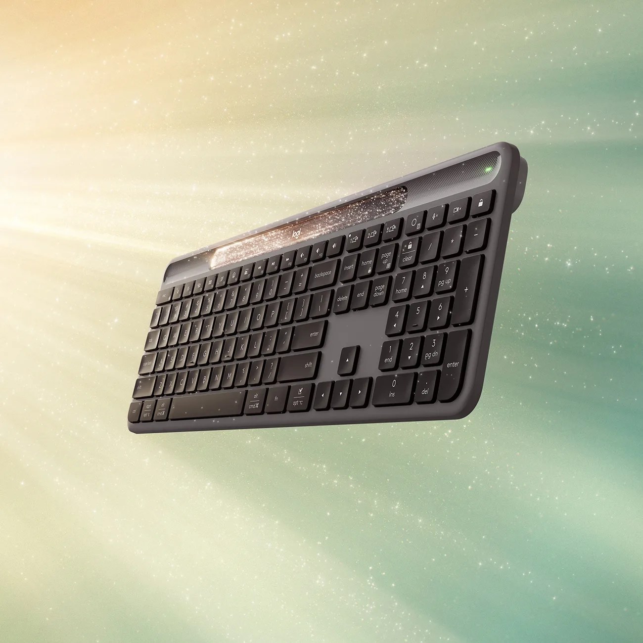 A sleek, black wireless keyboard with a numeric keypad, floating against a soft gradient background of green and beige with sparkling light effects. The keyboard features a slim profile and a glowing light bar above the function keys.