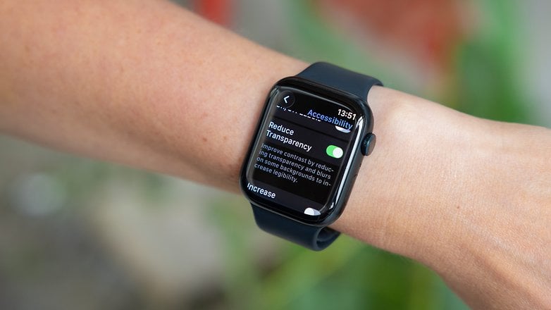 A person's wrist with an Apple Watch displaying accessibility settings.