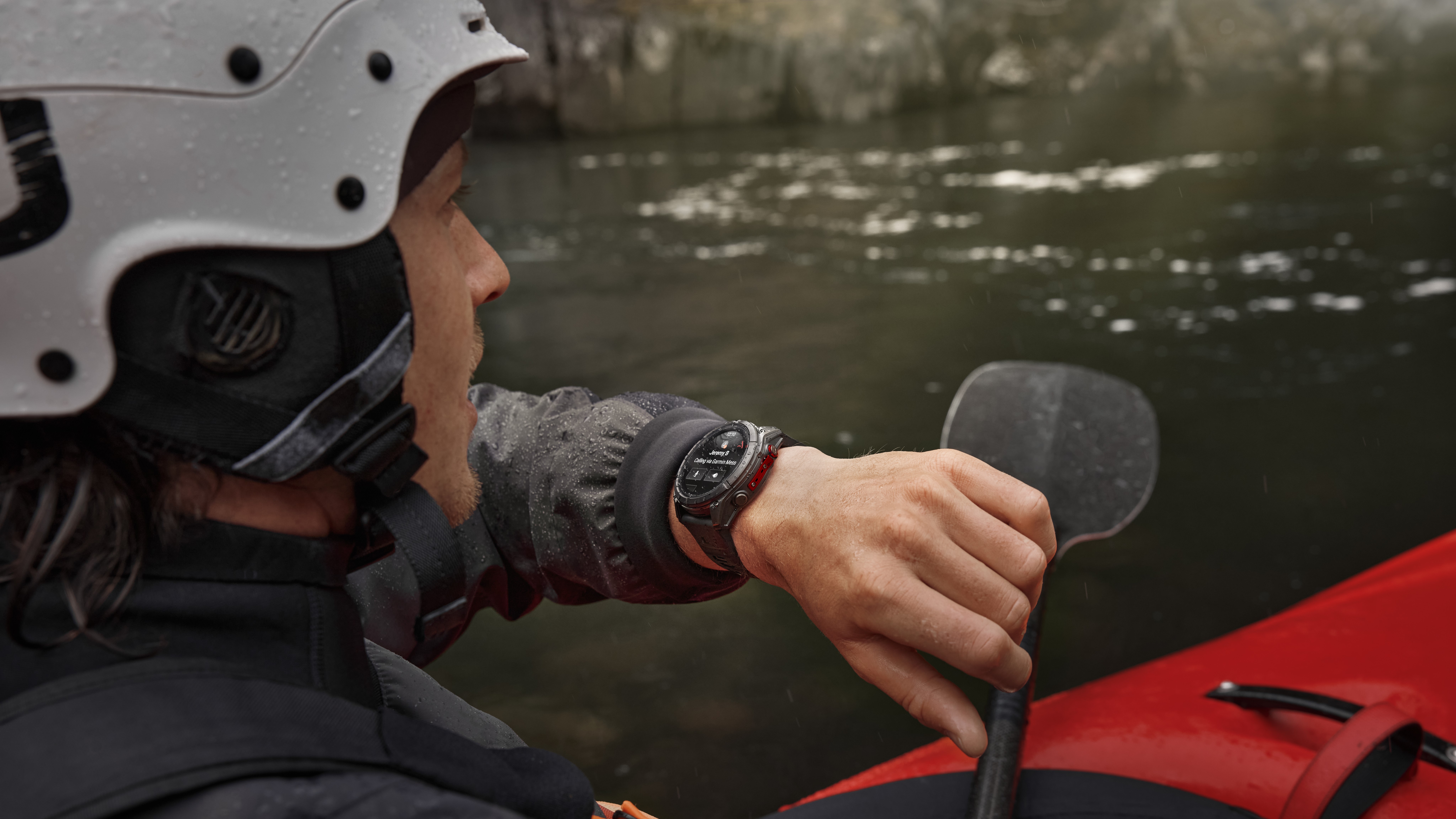 A photo of a person kayaking while wearing a Garmin Fenix 8 Pro, using it to call someone using LTE cellular data.