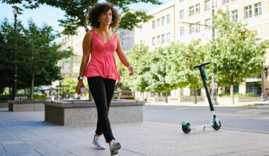 Woman walking in city on sunny day