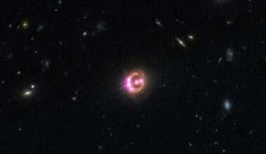 An image of a glowing orange and purple halo in outer space