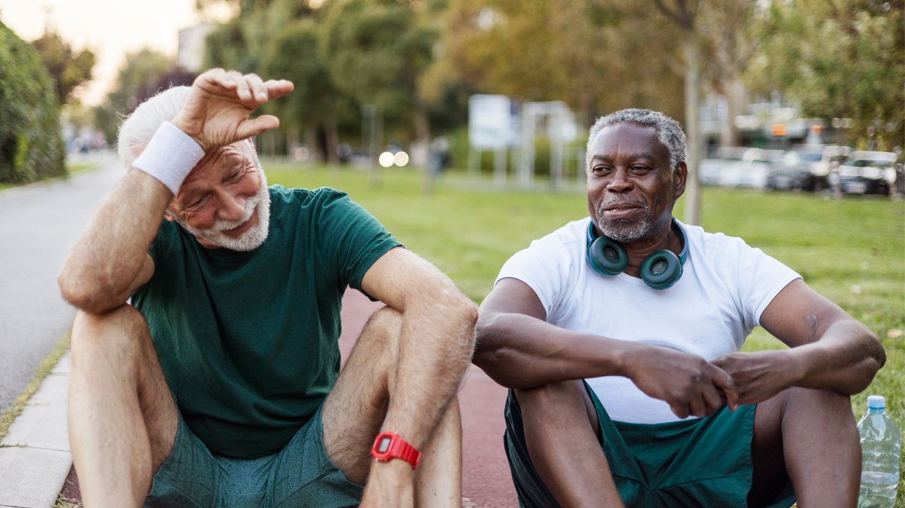 Two older males resting after exercising outdoors