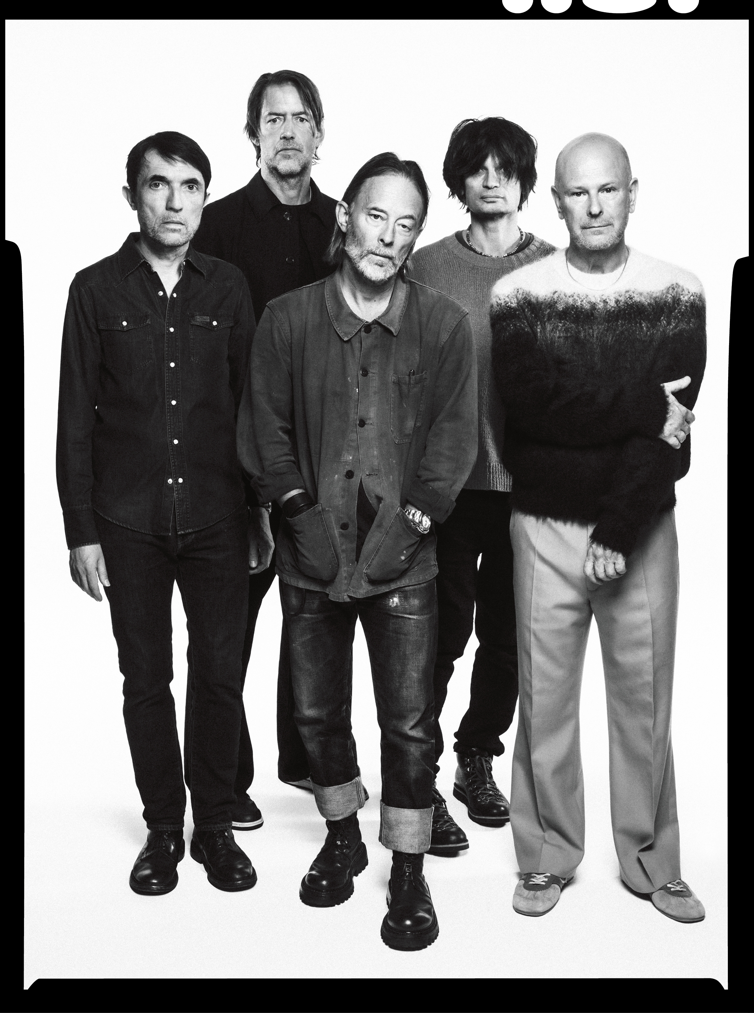 A black and white studio portrait of the band The Smile.