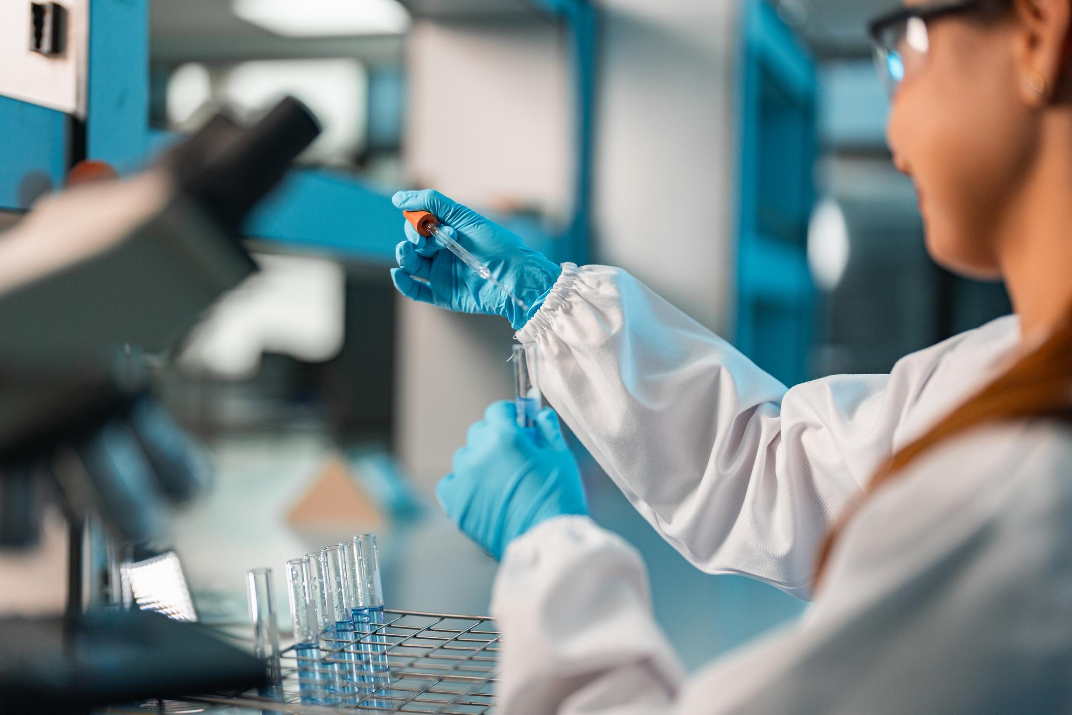 Young female scientist conducting research in a lab.