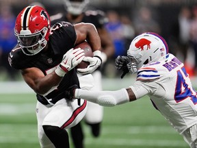 Atlanta Falcons running back Bijan Robinson runs past Buffalo Bills cornerback Christian Benford during a game.