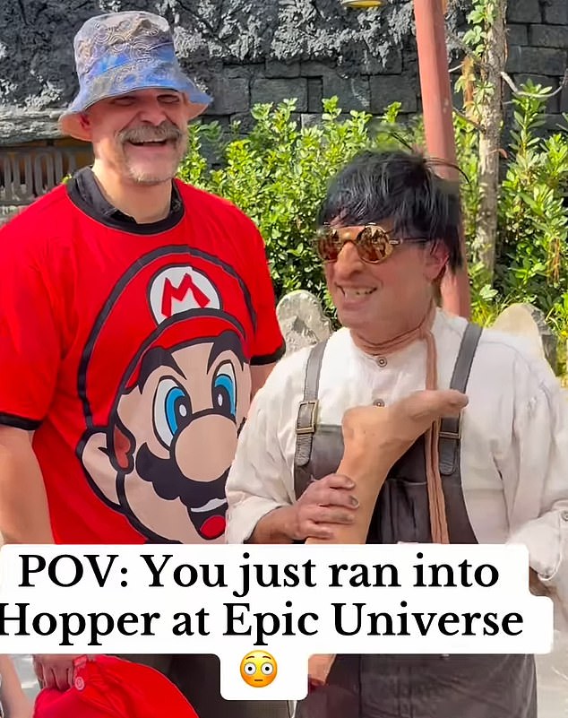 David Habour stops for a picture with a fan while wearing a red Mario T-shirt during a day out at the Epic Universe theme park in Orlando, Florida, with Lily Allen's daughters