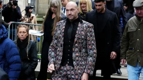 PA Media Tyson Fury is walking out of  the funeral service for Ricky Hatton at Manchester Cathedral. His brother Tommy is walking behind him. 
