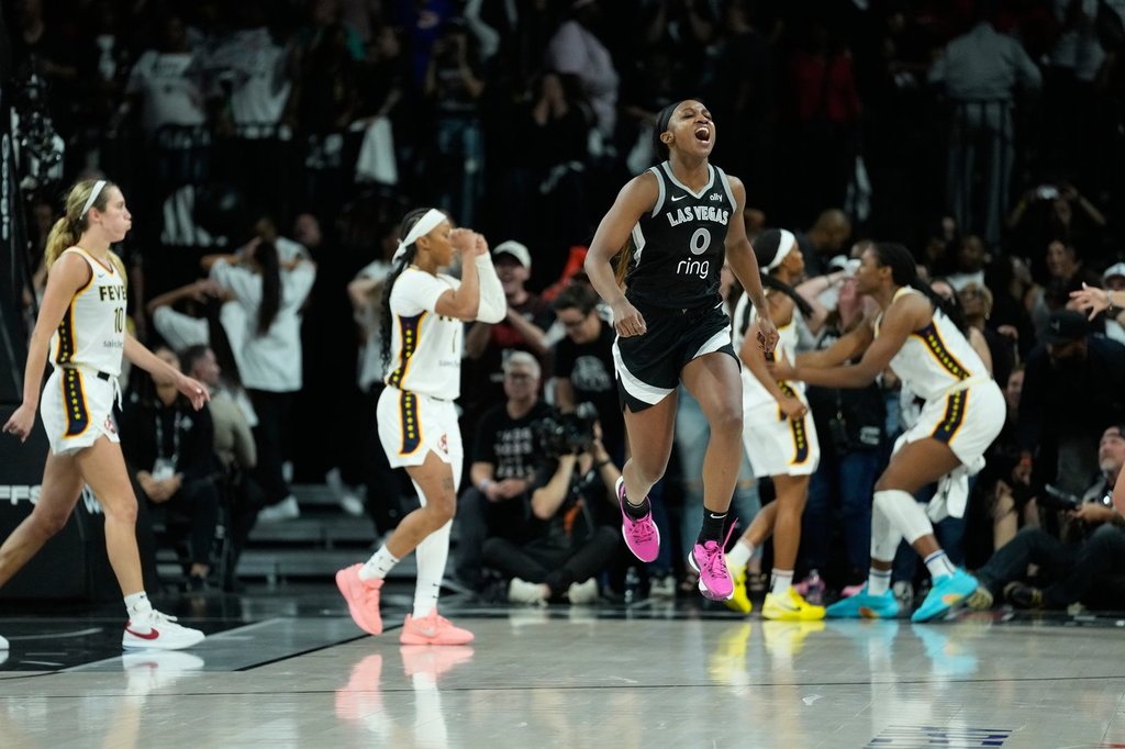 Las Vegas Aces guard Jackie Young (0) reacts after a play against the Indiana Fever during the second period in Game 5 of a WNBA basketball playoff semifinals series Tuesday, Sept. 30, 2025, in Las Vegas. (AP Photo/John Locher)