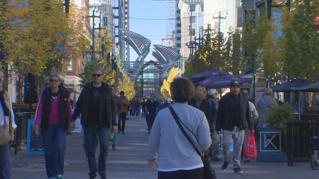 People walk on Calgary's pedestrian street Stephen Avenue on a sunny day