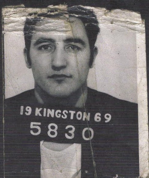 Black and white photo of a man being sent to prison 