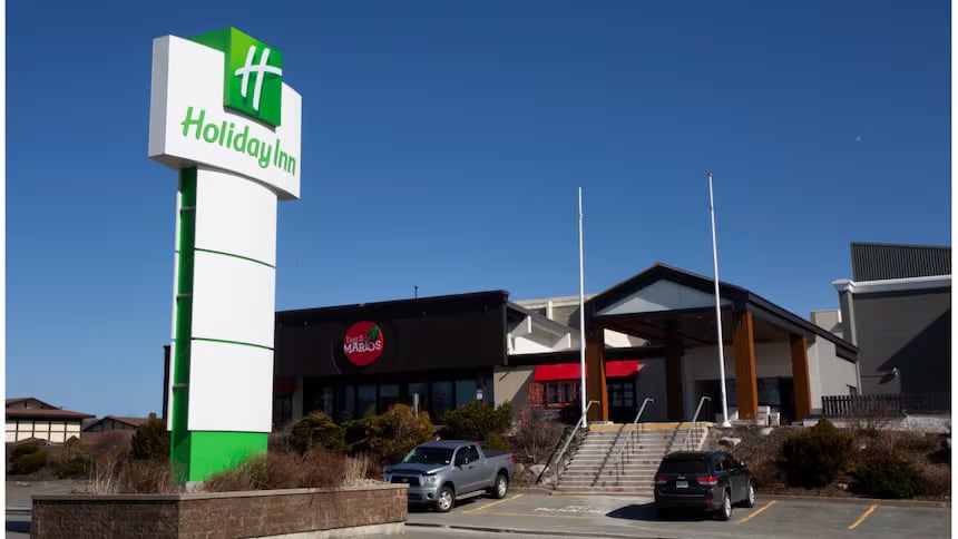 Parking lot of hotel with chain restaurant in background