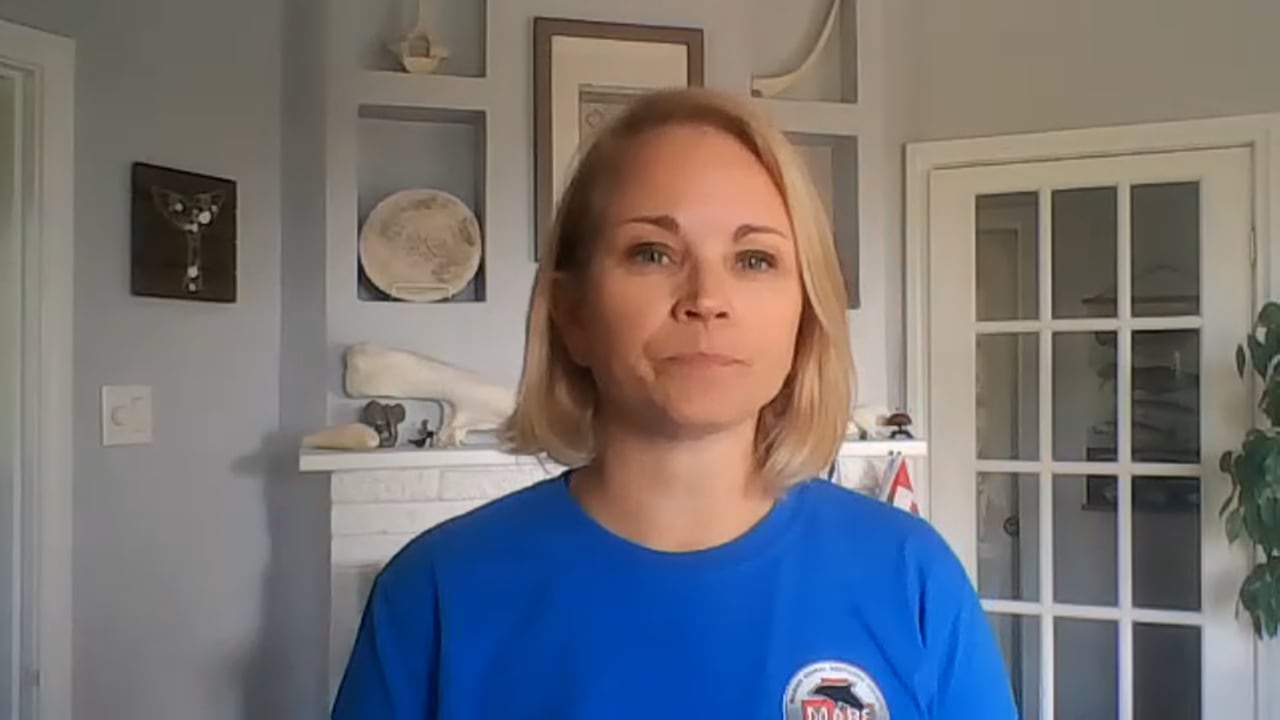 A woman with blonde hair wearing a blue t-shirt