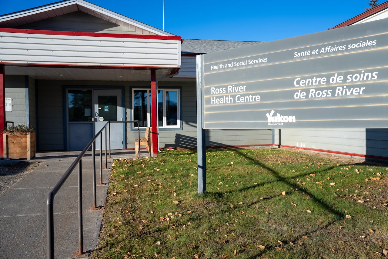 A sign outside of a building says 'Ross River Health Centre.'